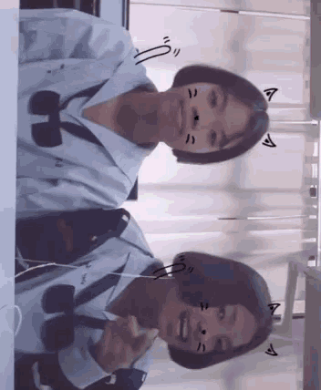 two girls are sitting next to each other and one has a cat face drawn on her face .