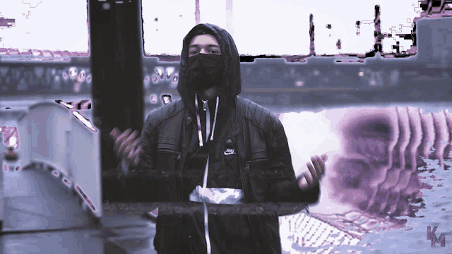 a man wearing a mask and a nike jacket stands in front of a purple background