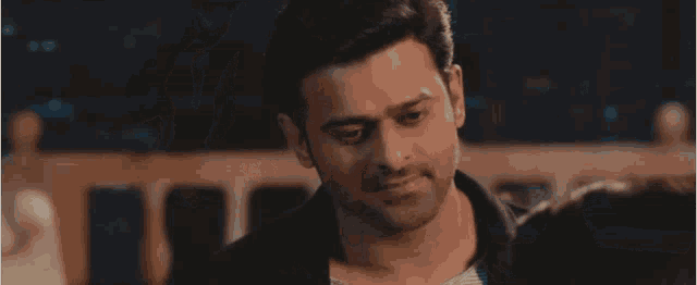 a close up of a man 's face with a woman behind him .