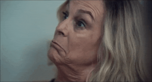 a close up of a woman 's face making a funny face