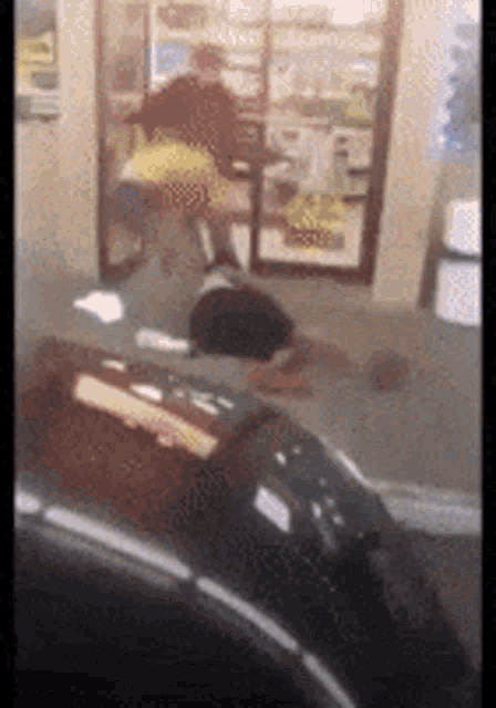 a blurred image of a person standing in front of a window in a store .