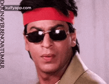 shah rukh khan is wearing sunglasses and a red headband .