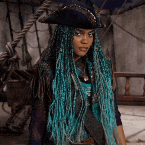 a woman with blue braids is wearing a hat