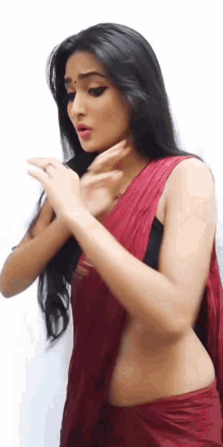a woman wearing a red saree and black bra