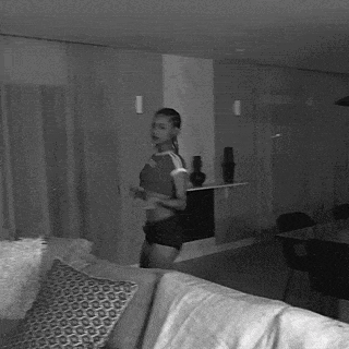 a black and white photo of a woman in a room