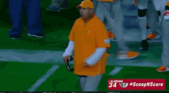 a football player with the number 2 on his jersey talks to a coach