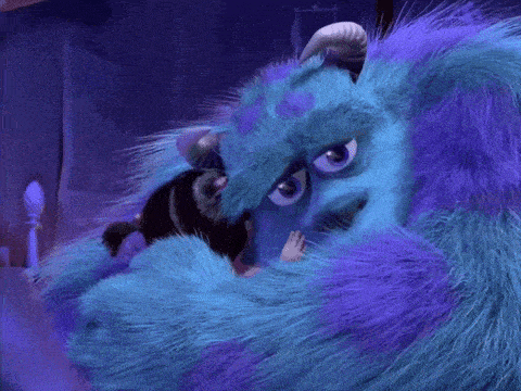 a blue and purple furry monster with horns is hugging another monster