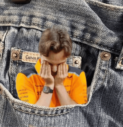 a man in a calvin klein shirt is covering his face with his hands