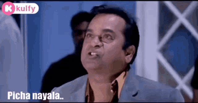 a man in a suit and glasses is making a funny face and saying picha nayala .