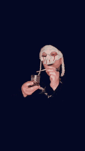 a person wearing a skull mask with blood coming out of it