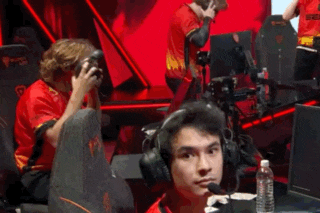 a group of people wearing headphones are sitting in front of a computer .