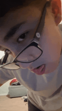 a close up of a person wearing glasses with the letter o on it