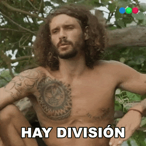 a shirtless man with a tattoo on his chest is sitting in the woods and says hay division