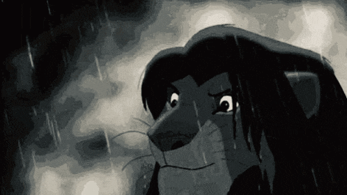 a black and white photo of a lion from the lion king in the rain .