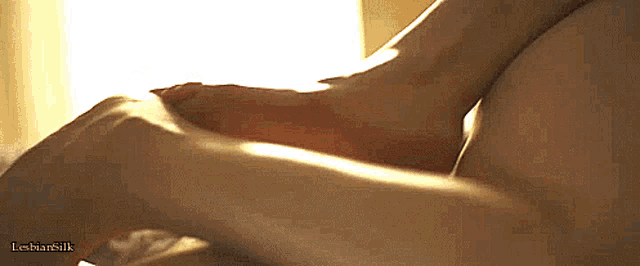 a close up of a person 's hand on another person 's breast with the words lesbian silk visible