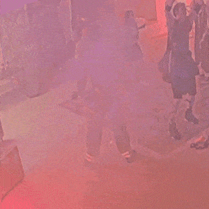 a group of people are dancing in front of a sign that says ' aa ' on it