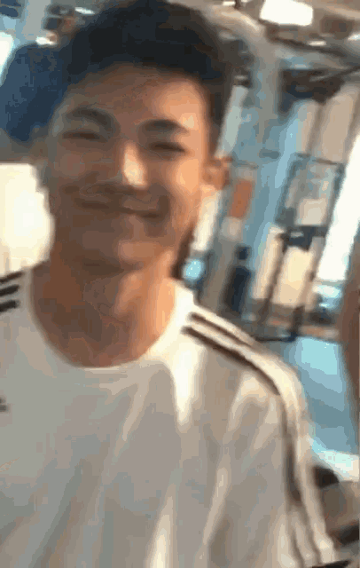 a man wearing a white shirt with black stripes is smiling