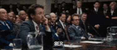 a group of people are sitting around a table and the word ser is visible
