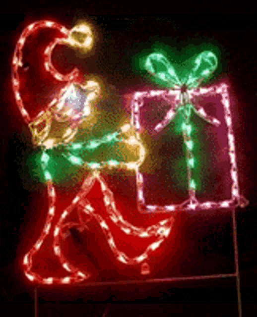 a christmas decoration of a elf holding a gift box
