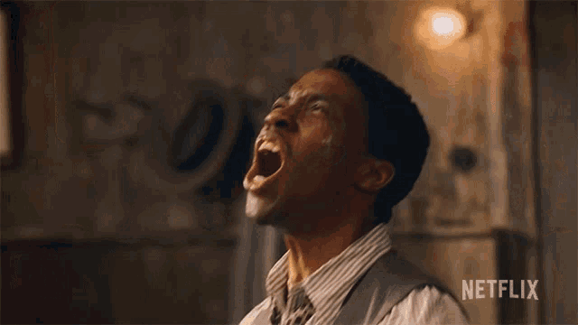 a man is screaming with a netflix logo in the background