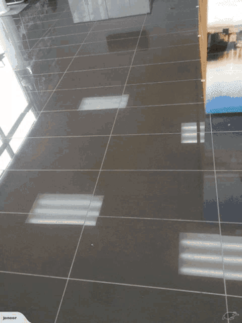 a picture of a tiled floor with a bottle of dewalt sitting on the floor