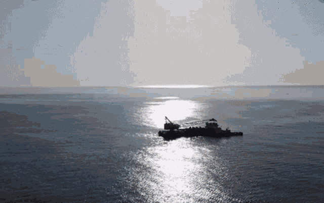 a large body of water with a boat in the middle of it