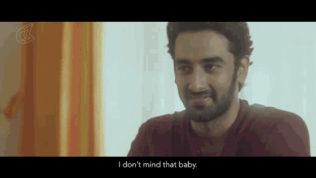 a man in a maroon shirt says i don 't mind that baby