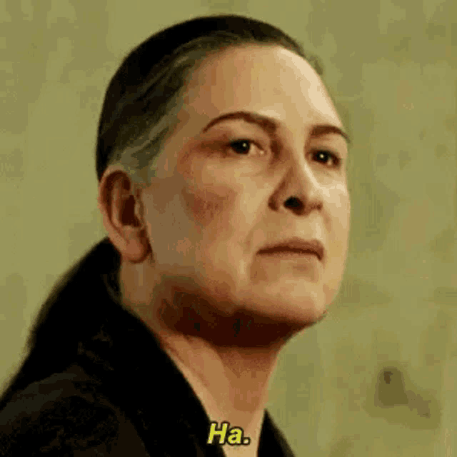 a close up of a woman 's face with the words `` ha '' written next to her .