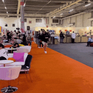 a group of people are gathered in a large room with a sign that says ' l' exposition ' on it