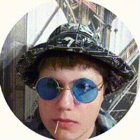 a man wearing a hat and sunglasses with a toothpick in his mouth