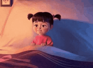 boo from the movie monsters inc is sitting in a bed