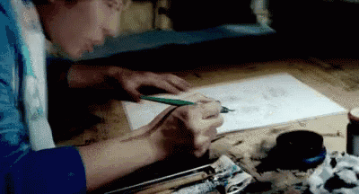 a person is drawing with a pencil on a piece of paper .