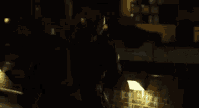 a man is holding a gun in a dark room .