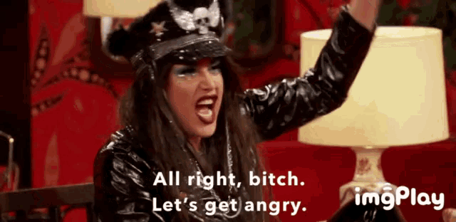 a woman wearing a hat and a leather jacket says all right bitch let 's get angry