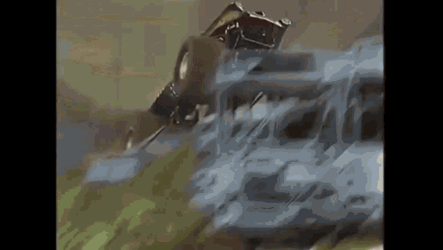 a train is going down a hill and a car is going down the tracks .