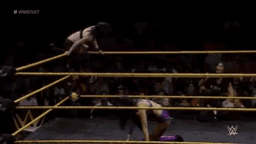 a woman in a wrestling ring with a w logo on the bottom