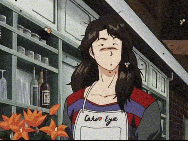 a woman in an apron is standing in front of a shelf .
