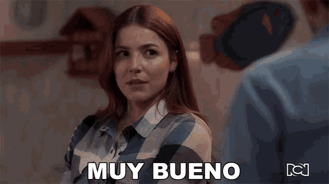 a woman in a plaid shirt says muy bueno in spanish