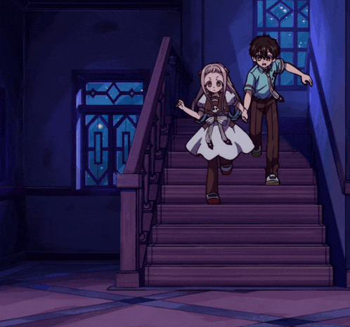 a boy and a girl are running down a set of stairs at night