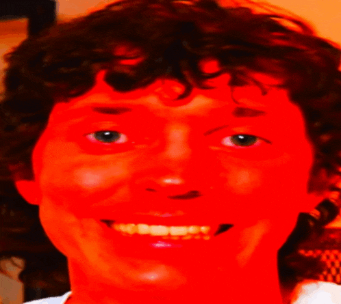 a close up of a person 's face with a red glow