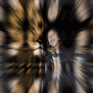 a blurry image of a person 's face with a lion 's face in the background