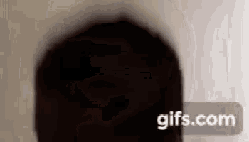 a close up of a person 's face with a gifs.com watermark on the bottom .