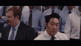 a group of men in suits and ties sitting in a room