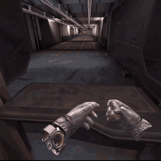 a person standing in a shooting range with a glove on their hand