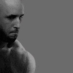 a man with a beard and a bald head is shown in a black and white photo
