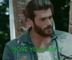 a man with a beard is standing in front of a door with the words move your body on it