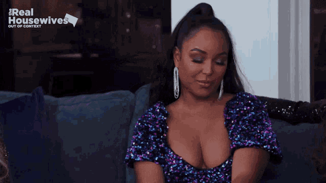 a woman is sitting on a couch with the words real housewives out of context