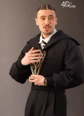a man holding a trophy with the number 40 on the bottom right