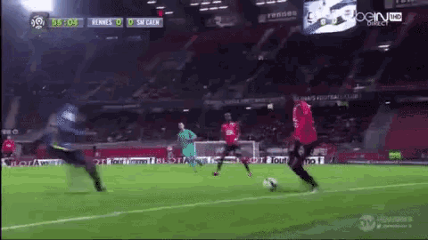 a soccer game is being played in a stadium sponsored by bein