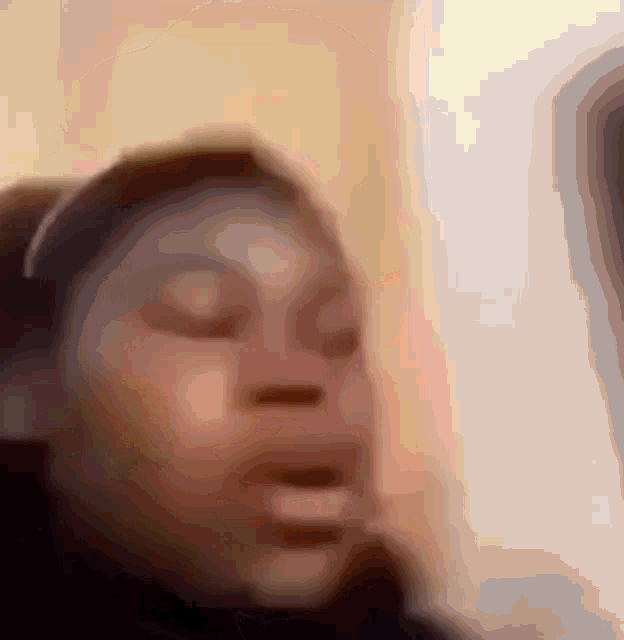 a blurry picture of a person 's face with their mouth open
